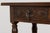 An early 20th century Spanish walnut console table sourced in Provence, France. Crafted from solid walnut, the table...