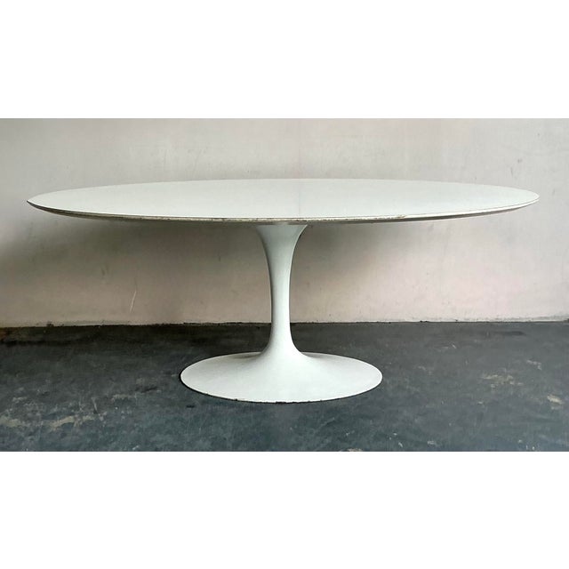 This expansive oval table top is defined by its clean lines and monumental scale, embodying the timeless grace of...