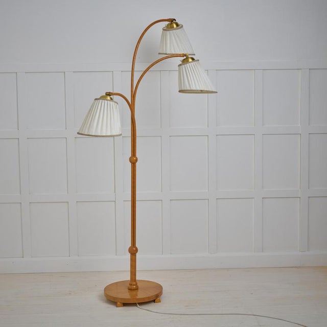 Scandinavian modern floor lamp from Sweden made during the mid 20th century, around 1940 to 1950. The base is solid elm...