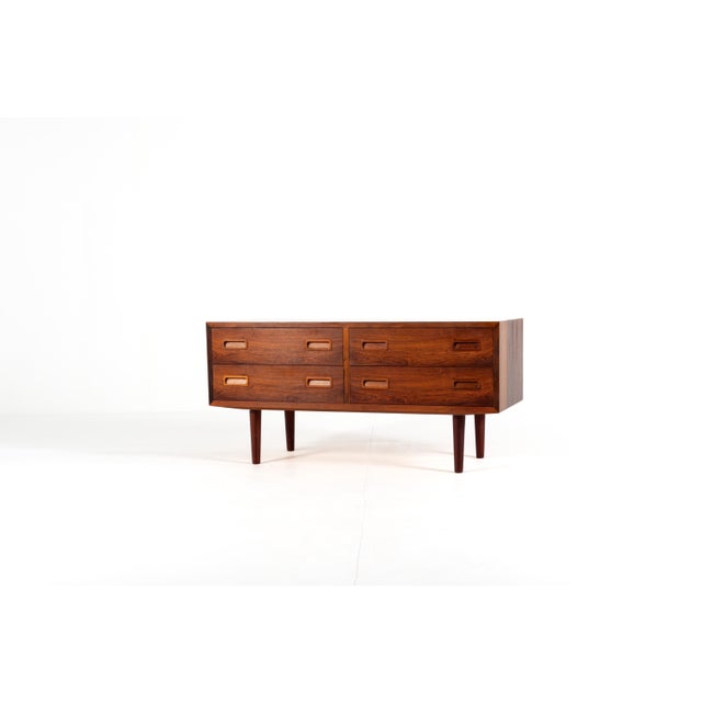 A beautiful low Danish chest of drawers from the 1960s, designed by Poul Hundevad for Hundevad & Co. Made in rosewood with...