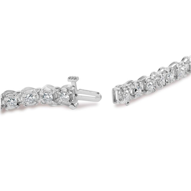Indulge in the ultimate luxury with this stunning 10K white gold tennis bracelet. Adorned with 3.00 cttw of natural...