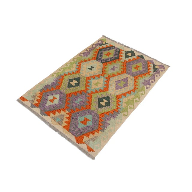Add a touch of elegance to your home with this casual chic hand woven Tribal Kilim wool rug. Constructed on a loom by...