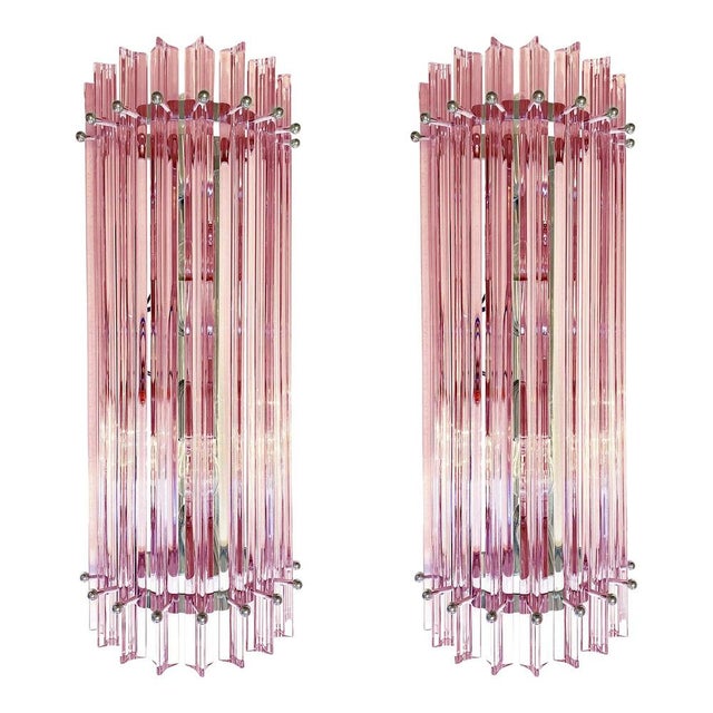 Set of two scenographic pink triedro murano glass wall sconces. very elegant , very bright. metal frame in chromed plating...