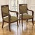 Elegant in both form and proportion, this exceptional pair of French Empire Period fauteuils embodies the refined...