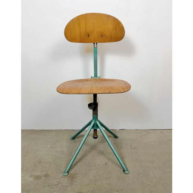 This industrial height adjustable, rotating chair was made in former Czechoslovakia during the 1950s.It features a dark...