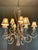 Elegant chandelier in metal and stone, featuring nine lights surrounded by silk lampshades. Purchased in the late 1990s....