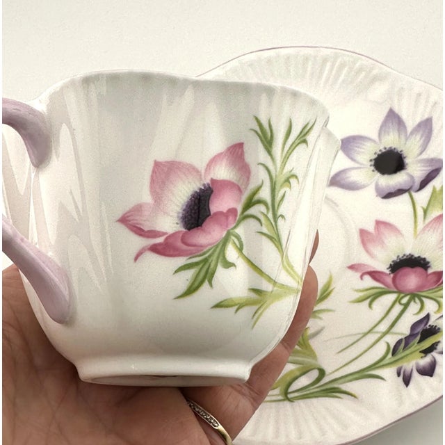 This Dainty Shape Shelley tea cup is decorated in the Wind Flower pattern (No. 14032). Made of fine English bone china,...