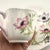 This Dainty Shape Shelley tea cup is decorated in the Wind Flower pattern (No. 14032). Made of fine English bone china,...