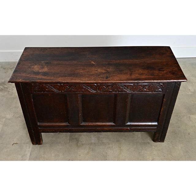 A French, solid oak coffer from the 1800s, this heavy storage trunk has a paneled exterior counterbalanced with hand-...