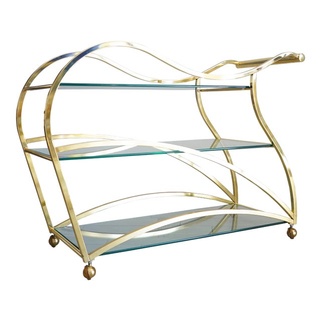 Late 20th century "Flow" bar cart by Design Institute of America (DIA) with three glass shelves. Sculptural, curved lines...