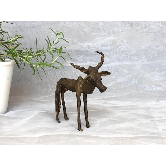 This vintage African bronze male kudu antelope sculpture would make an interesting home decor accent on a living room...