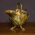 A superb brass coal helmet from the Edwardian period. With cast brass claw feet and ebony grips to the handles, along with...