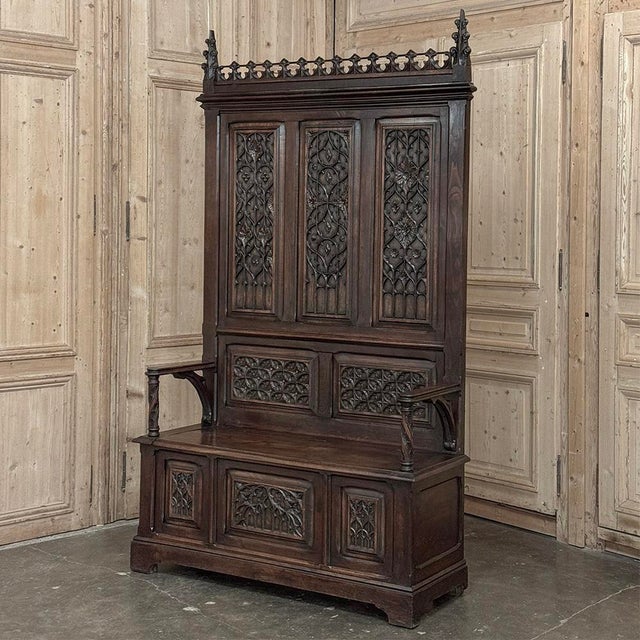 19th Century French Gothic Hall Bench with Trunk is a stately example of the genre which dates back to the middle of the...