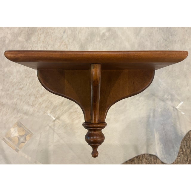 Vintage wooden wall shelf perfect for displaying a favorite vase, small painting or antique plate. MAKER'S MARK: None...