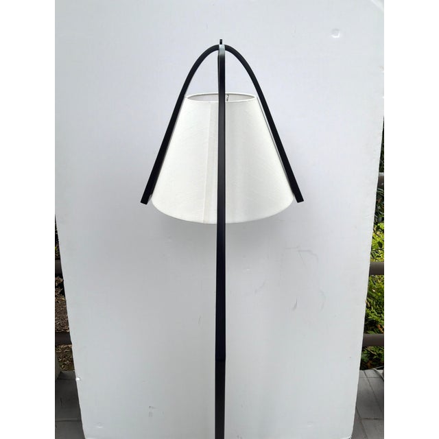 Stylish Currey & Co Frey Black Floor Lamp. Black arched body, black base. White tapered shade. Original Retail $1340....