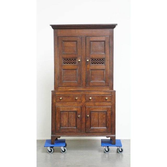 Offered this very nice antique English oak food cupboard/stock cabinet from the late 18th/early 19th century. What do we...