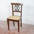 This 18th-century-style chair represents a refined example of classic furniture, ideal for lovers of antiques and period...