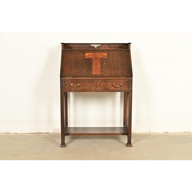 A rare and exceptional antique Mission or Arts & Crafts period quarter sawn oak cut-out drop front secretary desk In the...