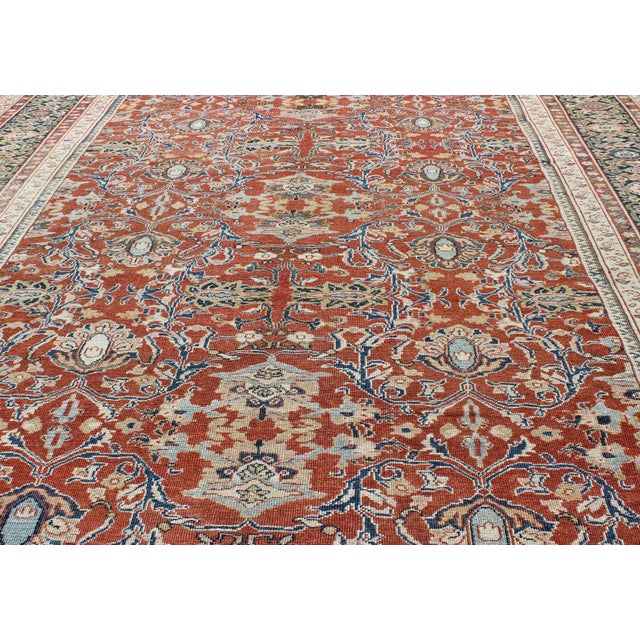 Antique Sultanabad Rug with Large Flower Design in Soft Red Field. All Over Design Antique Sultanabad Rug. Keivan Woven...