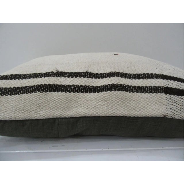 This is a pillow cover made from a vintage kilim rug. The piece was properly washed and ready to use. Pillow inserts not...