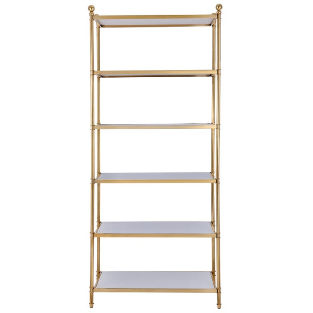 The Nuva Étagère features six ivory ceramic shelves set within a gold-plated stainless steel frame. Round accents atop the...