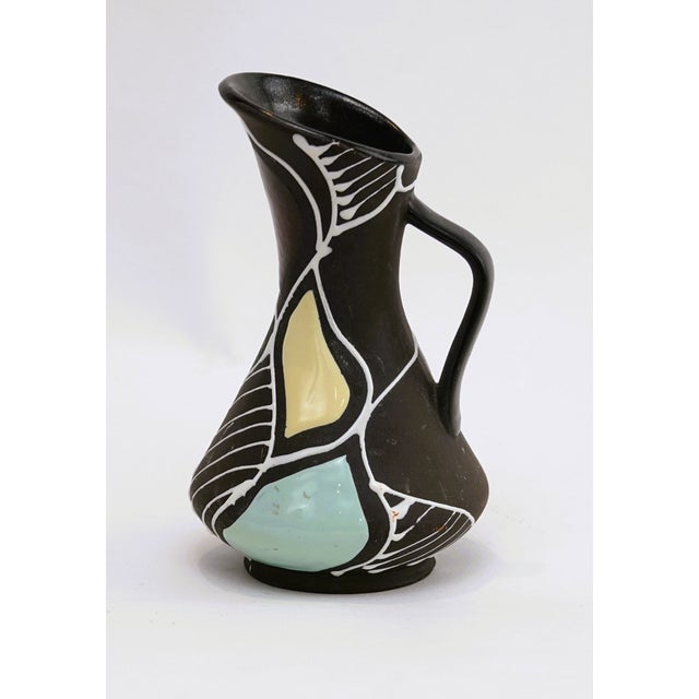 A charming handled pitcher vase in the "Trinidad" decor, designed by Bodo Mans for Bay Keramik, West Germany. Model...