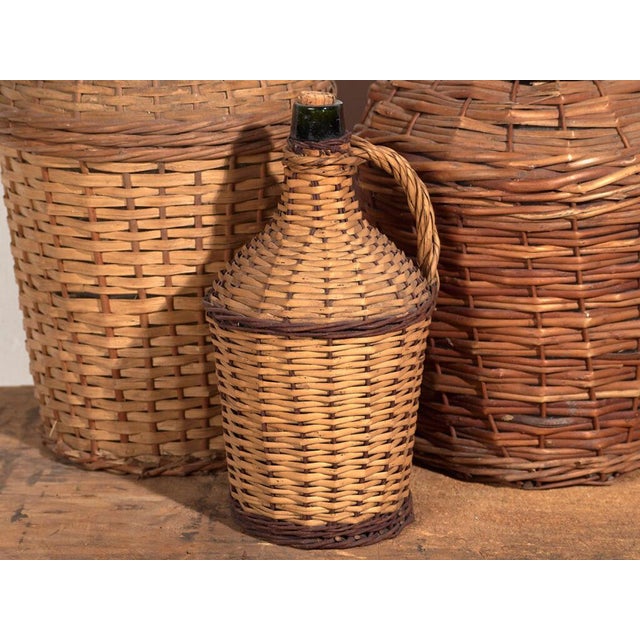 Antique glass and wicker demijohns (c.1920) Style: French Provincial Materials and techniques: Glass, wicker Place of...
