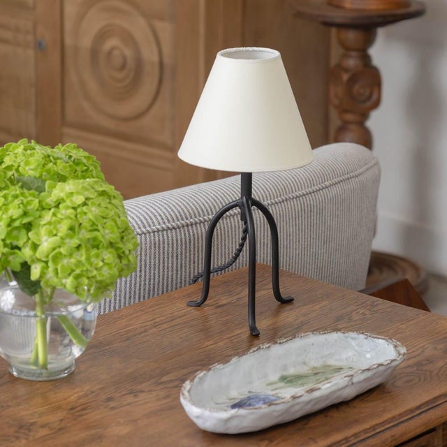 Petite iron tripod lamp with slender legs and tapered feet. New wiring and new parchment shade. Sold individually and...