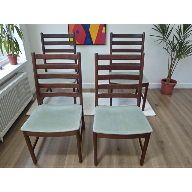 Transform your dining space with this exquisite set of four Mid Century White & Newton vintage dining chairs, impeccably...