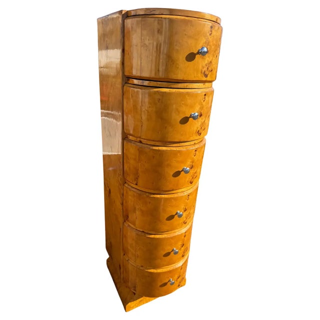 This a 6 drawer chest made of burl wood. The chest has a semi-circular shape wit chrome pulls. The base is plinth with a...