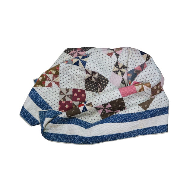 This charming, vintage handmade patchwork quilt features a beautifully executed Pinwheel variant design arranged within a...