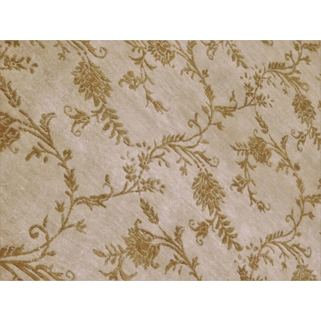 Tone on tone with beige background with allover floral pattern in gold tone. Wool pile on cottton foundation. 5'7"x 8'
