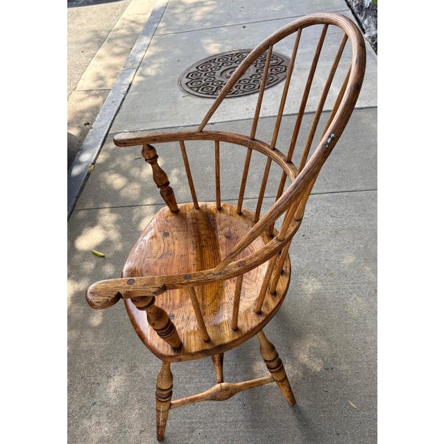 This fine hand crafted New England 19thc extended arm Windsor chair in a natural unpainted surface. The natural chair is...