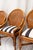 Set of four vintage chairs featuring bamboo frames and distinctive rounded caned backrests. The seats have been completely...