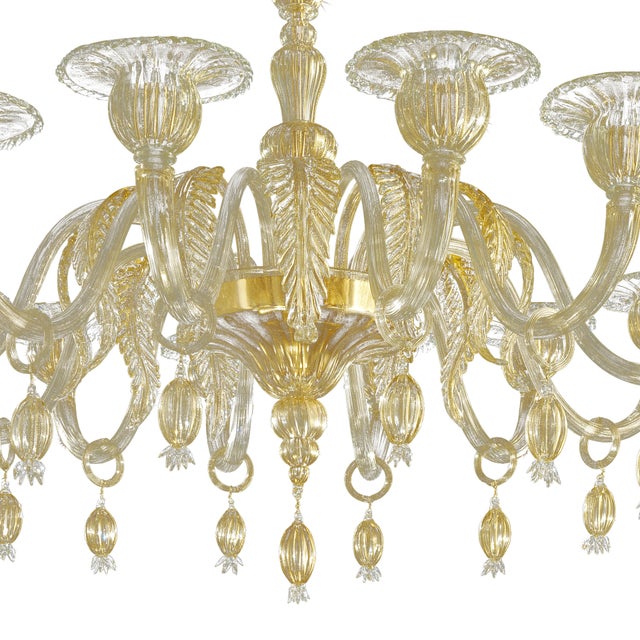 Elegant chandelier in transparent and gold Murano glass and gold metal frame. For classical and modern interiors, a piece...