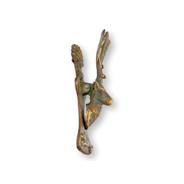 Antique English solid brass deer head door knocker featuring a sculptural stag form with expressive antlers and a richly...