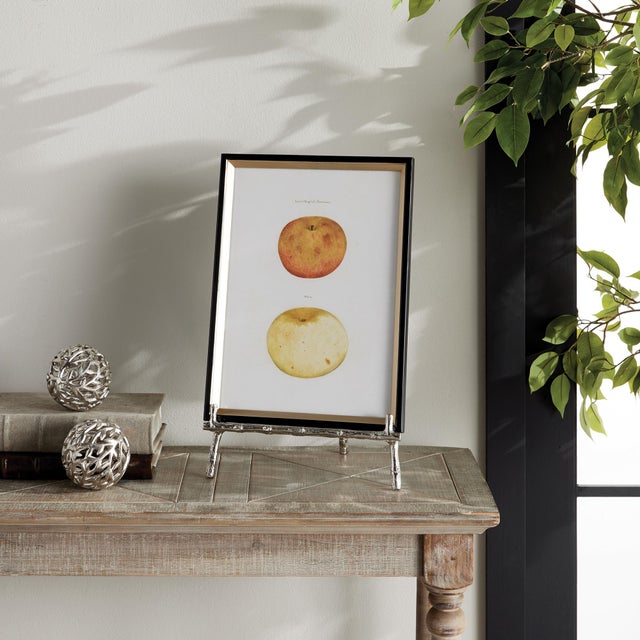 Made to hold platters, cookbooks or a small piece of art, this easel is strong and sturdy. The silver bamboo-like details...