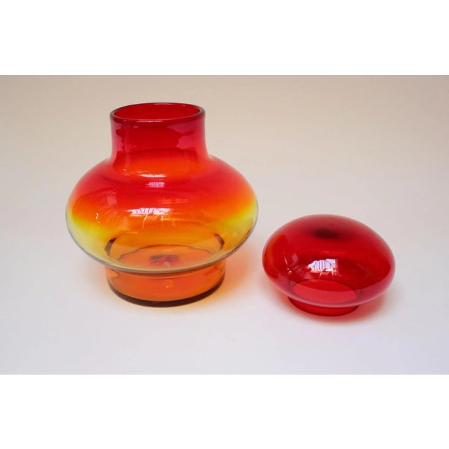 Large blown glass amberina/tangerine lidded jar designed by John Nickerson for Blenko (model number 7328). This model...