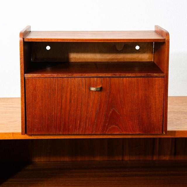 Wall mounted single compact cabinet / nightstand with single drop down surface. Made of teak. Imported directly from...