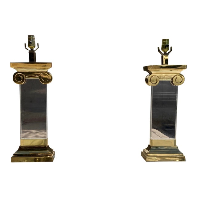 Fine pair of neoclassical brass and lucite ionic column table lamps, with 1” thick lucite column body, lucite finials on...