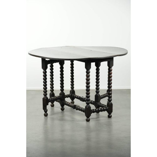 This beautiful antique English oak gateleg table dates from the late 17th/early 18th century and features beautiful turned...