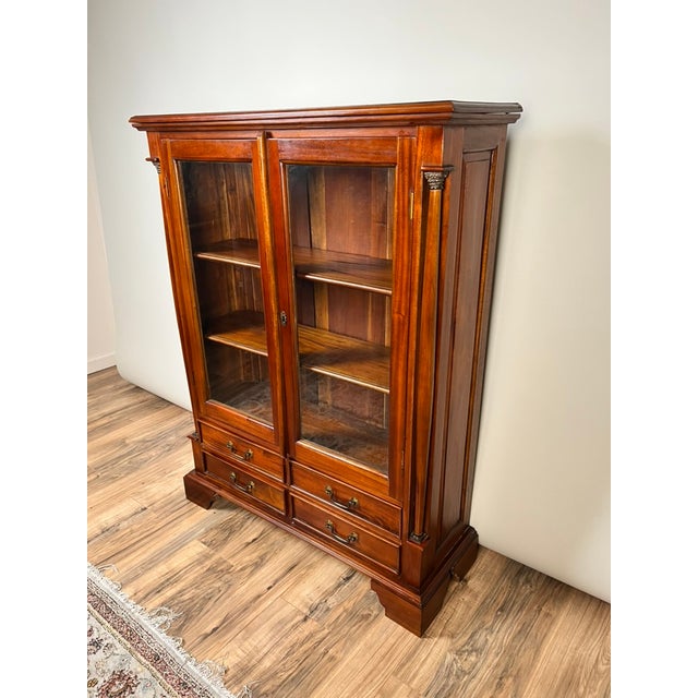 This vintage Victorian‑style bookcase combines refined design with practical storage. With its paneled glass doors and...