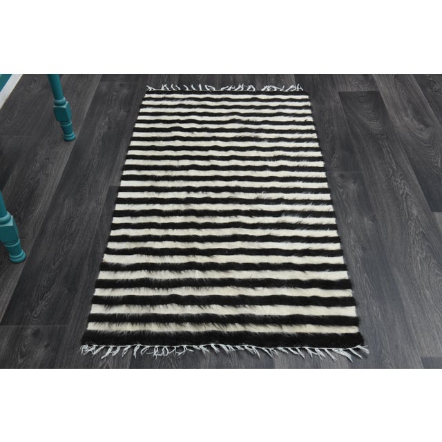 Vintage Turkish Hand-Knotted vintage rug is a vintage kilim area rug.'70s Eastern region of Turkey's unique rug is...