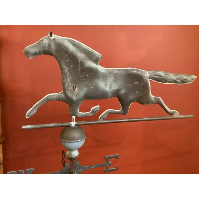 Vintage ‘folk art’ copper weathervane with directionals. Iron pole. Please note base NOT included. Measures 60.5” high,...