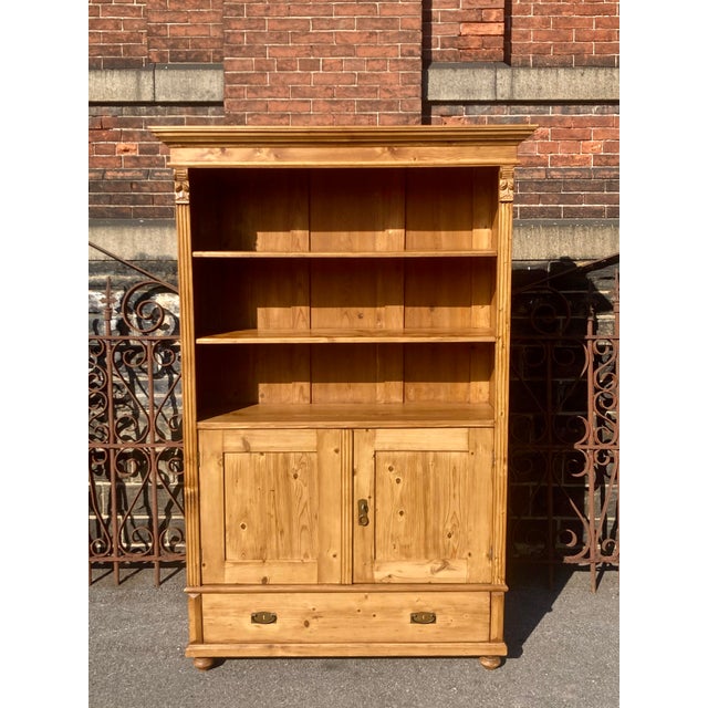 Antique pine bookcases are hard to find so the shell of this piece was provided by a vintage pine armoire. With one board...