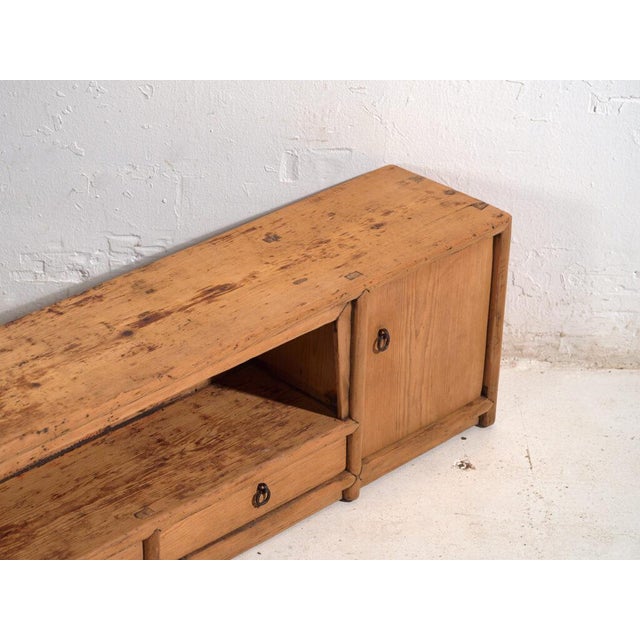 Antique low sideboard in pine wood, traditional Chinese furniture originating from Gansu and dated circa 1930. Originates...