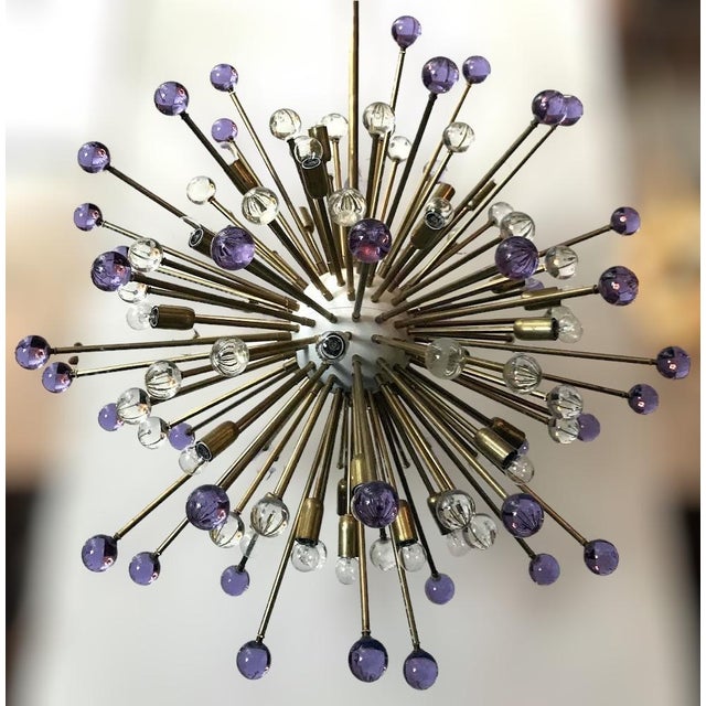 Italian modern Sputnik chandeliers with hand blown lilac and clear Murano glass spheres, mounted on natural brass frames...