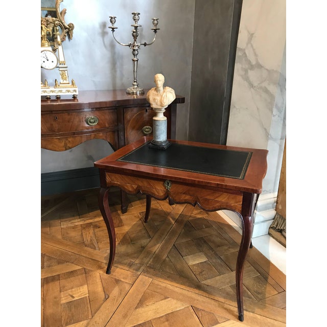 This elegant Gustavian writing table was made in the late 18th century out of kingwood and tulipwood with solid mahogany...