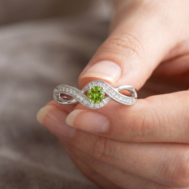 This elegant ring features a captivating Peridot gemstone, admired for its luminous lime-green glow and refreshing appeal....