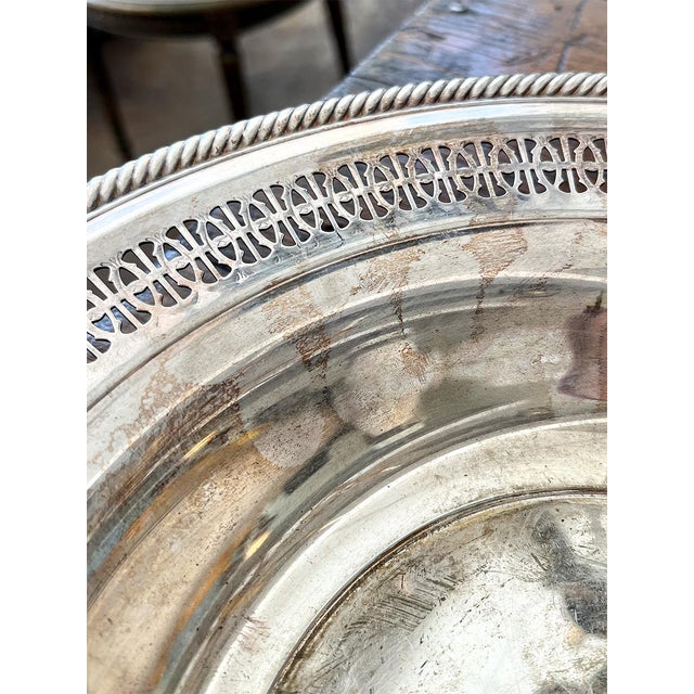 This is a reticulated dish with a beautiful, intricate border. This silver-plated bowl was created by William Rogers.